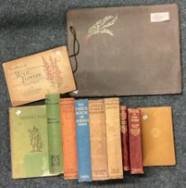 A collection of leather-bound books and cigarette cards.