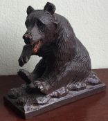 A small Black Forest carved seated bear.