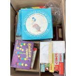 A box containing old children's games including Fuzzyfelt, Beatrix Potter jigsaw puzzle etc.