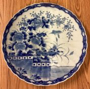 A large Chinese blue and white charger with floral decoration.