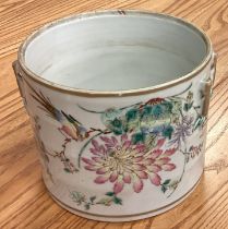 A large cylindrical Chinese basket decorated with flowers and bright colours.