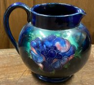MOORCROFT: A jug with floral decoration. Est. £20