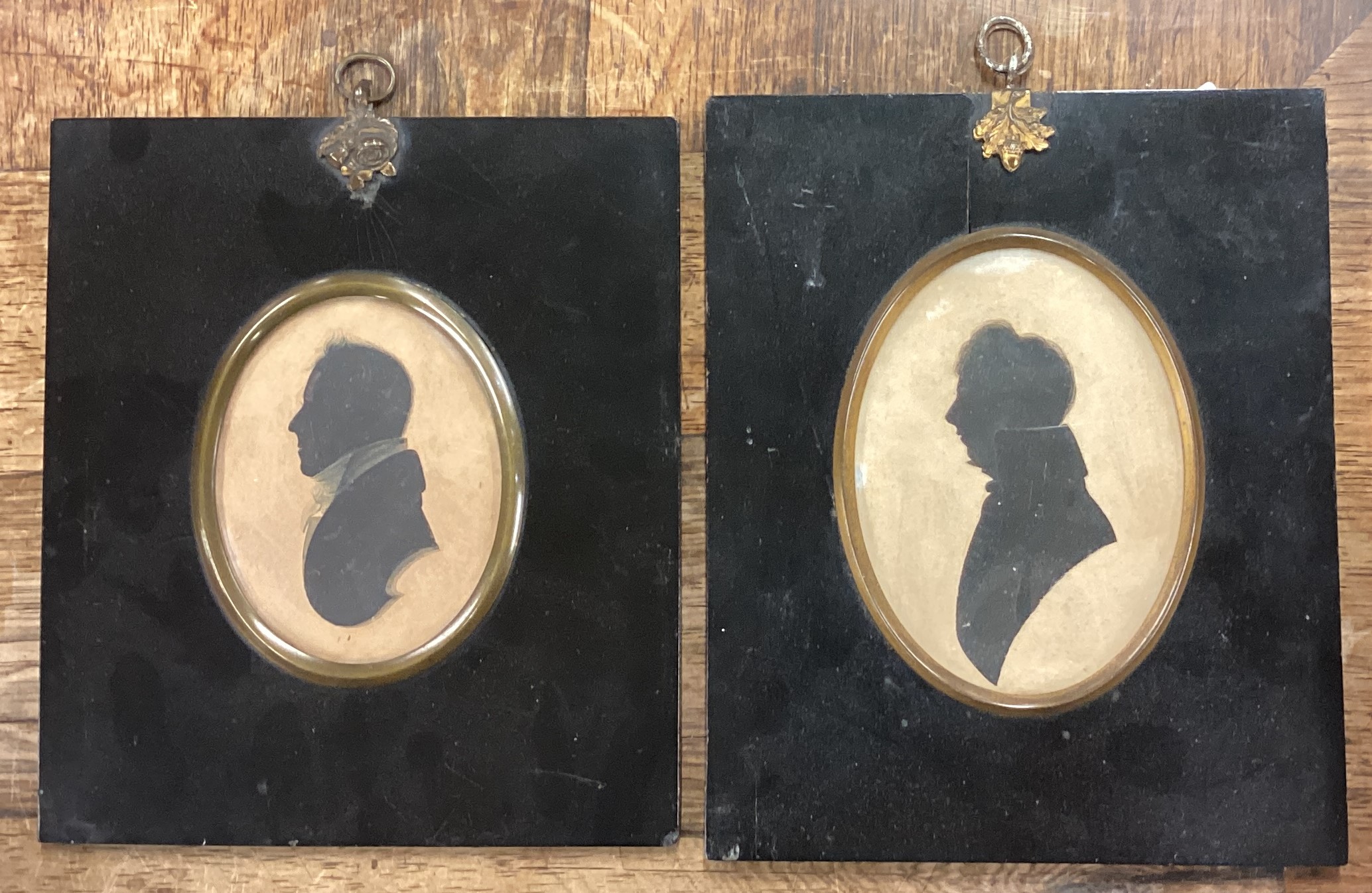 A pair of framed silhouettes.
