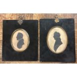 A pair of framed silhouettes.