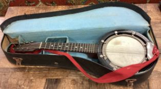 A cased John Grey banjo musical instrument.