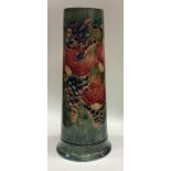 WILLIAM MOORCROFT: A tall "Pomegranate" spill vase on mottled green ground. Made for Liberty & Co.