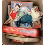 A box containing children's board games, toys, jigsaw puzzles etc..