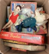 A box containing children's board games, toys, jigsaw puzzles etc..