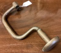 An Antique brass brace.