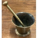 An Antique brass pestle and mortar.