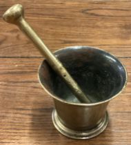An Antique brass pestle and mortar.