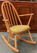 ERCOL: A small rocking chair. Est. £40 - £60.
