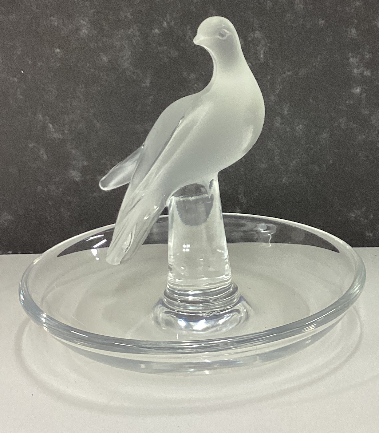 LALIQUE: A small glass pin dish decorated with figure of bird.