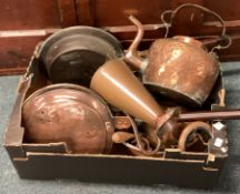 A box containing copper and brassware.