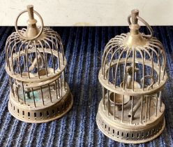 A pair of miniature brass bird cages.