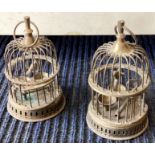 A pair of miniature brass bird cages.