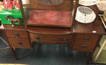 A mahogany bow front desk.