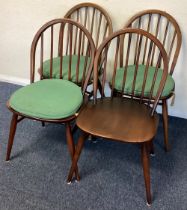 ERCOL: A set of four stick back chairs.