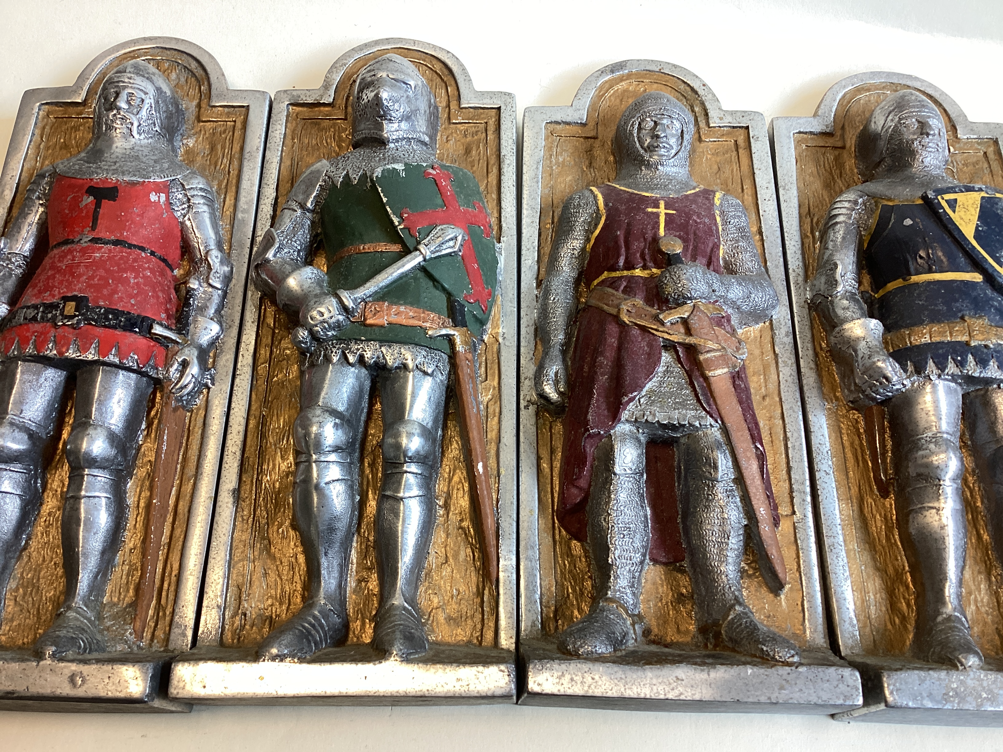 A set of four aluminium wall plaques depicting knights. - Image 2 of 3