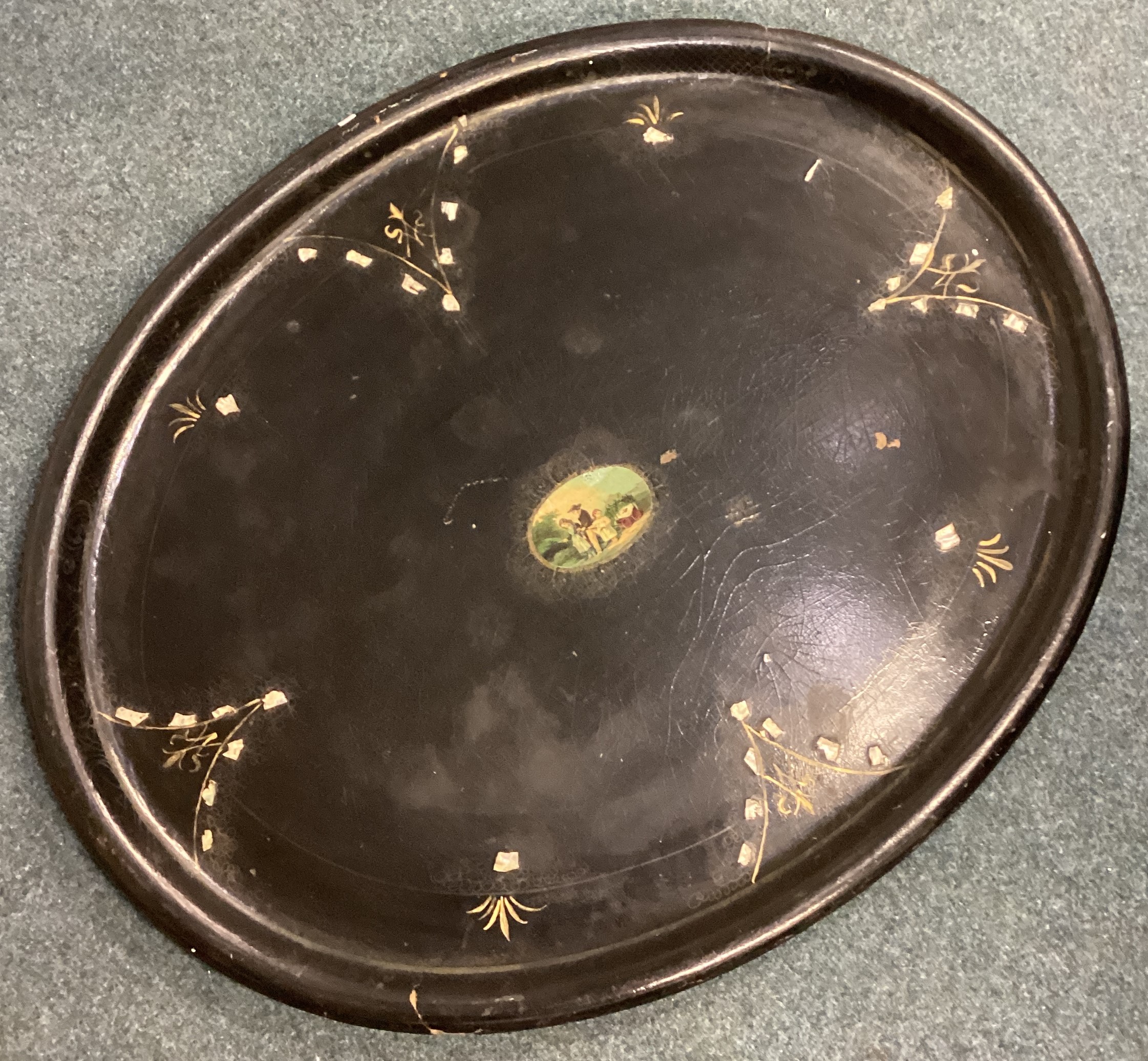 An oval paper mâché tray.