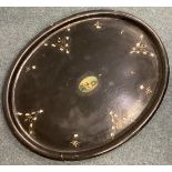 An oval paper mâché tray.