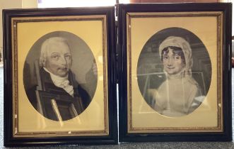 A pair of framed and glazed portraits of a lady and a gentleman in oval mounts.