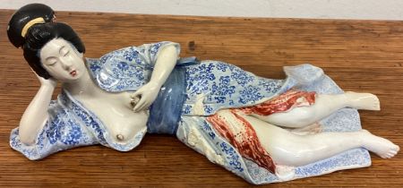 A good Japanese figure of a lady in recumbent position.