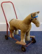 A small push along toy horse.