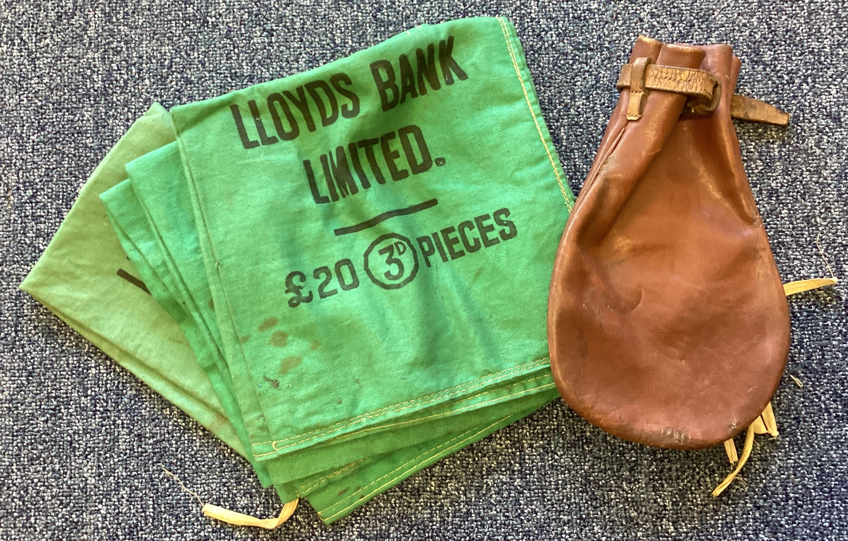 Four old Lloyds Bank coin bags together with a sovereign bag.