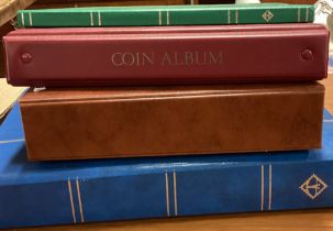 A collection of stamp and coin albums.