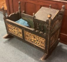 A continental carved rocking cot.