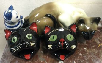 A quantity of pottery cats.