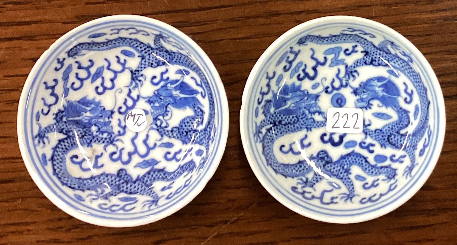 A pair of Chinese miniature blue and white dishes with dragon decoration. Signed to base.