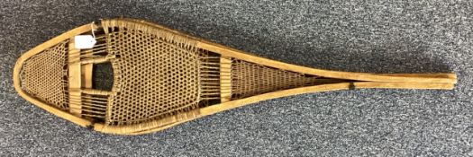 A pair of unusual wooden snow shoes.