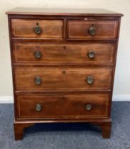 A mahogany chest of five drawers.