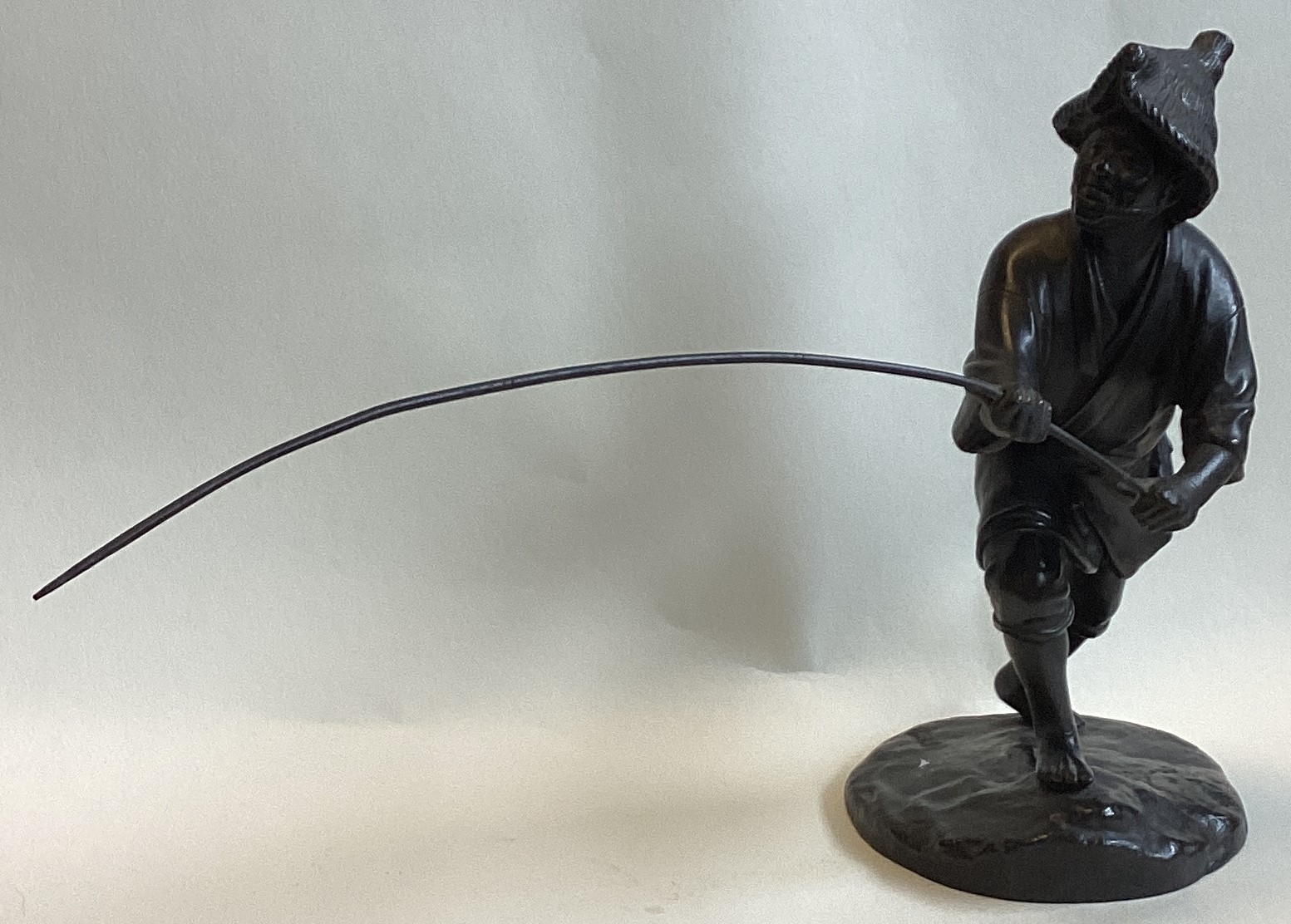 A good Chinese bronze of a gent fishing. Seal mark to base.