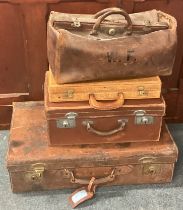 A group of leather suitcases.