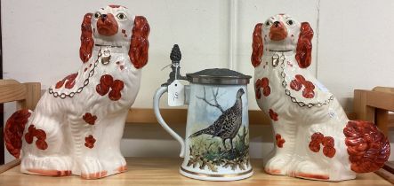A pair of Staffordshire dogs together with a pottery stein.