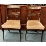 A pair of brass inlaid chairs.