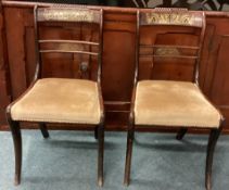 A pair of brass inlaid chairs.