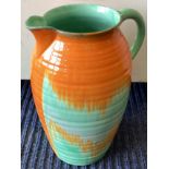 SHELLEY: A large green and orange glazed pottery jug.