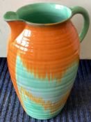 SHELLEY: A large green and orange glazed pottery jug.