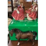Two Royal Doulton ladies together with a figure of a horse.