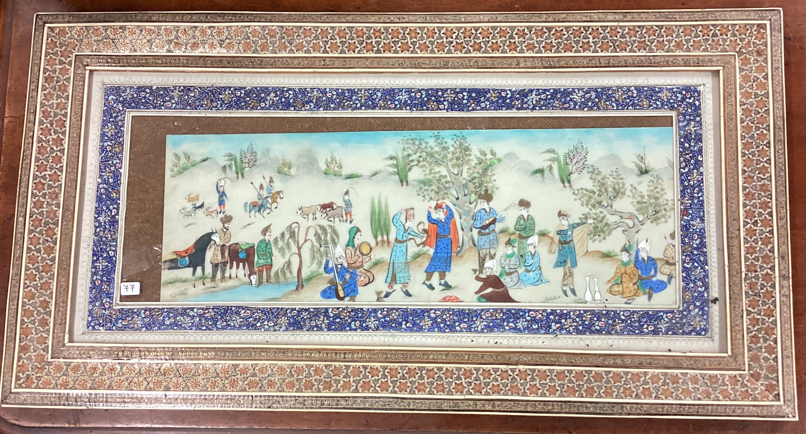 A painted Chinese picture decorated in bright colours.