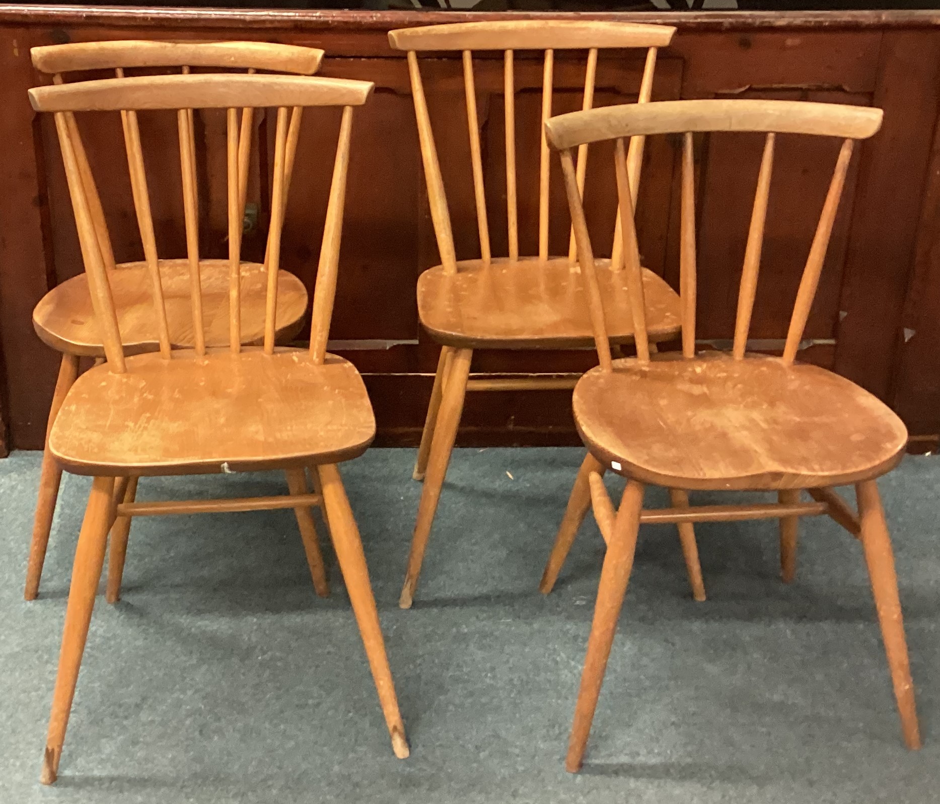 ERCOL: A set of four matched stick back chairs.