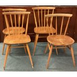 ERCOL: A set of four matched stick back chairs.