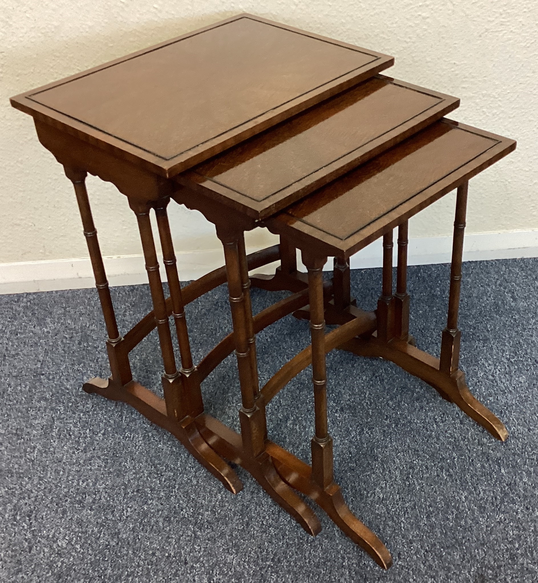 A mahogany nest of three tables.