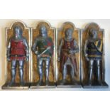 A set of four aluminium wall plaques depicting knights.