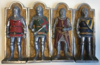 A set of four aluminium wall plaques depicting knights.