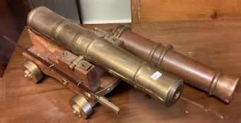 A large oak and brass model of a cannon etc.